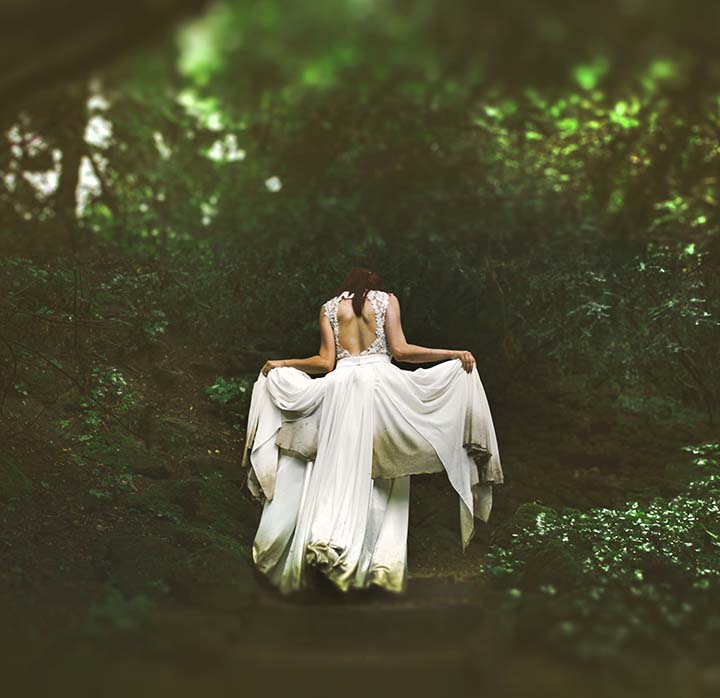 A woman in white in the woods